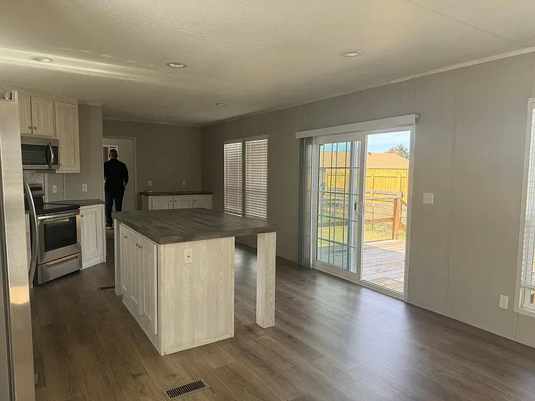 Open concept with great view through French doors to back yard and decking