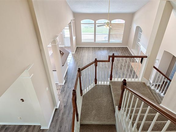 Balcony view of Family Room - Check out the large rooms that flow through the home. The large back yard is visible through the window. Kitchen and breakfast area are located to the left. Two way staircase, one way leads to the garage and study. The o