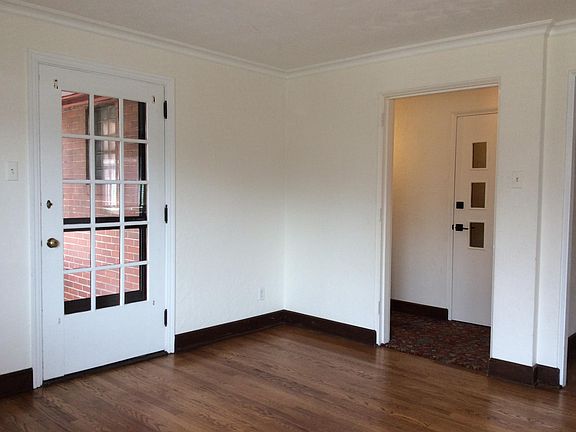 Main entrance door is on the right with hallway to second floor. Pane door is to private porch off of living room.