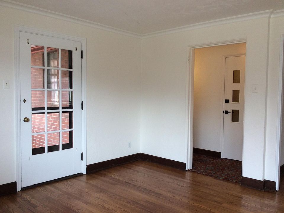 Main entrance door is on the right with hallway to second floor. Pane door is to private porch off of living room.