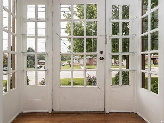 Interior view of the entry with glass display shelving.