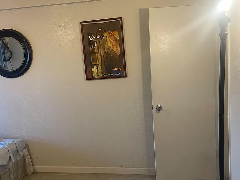 The room includes a mirror and two art-frames.