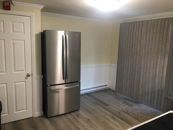 Backwall of Kitchen showing walkout slider to ground level