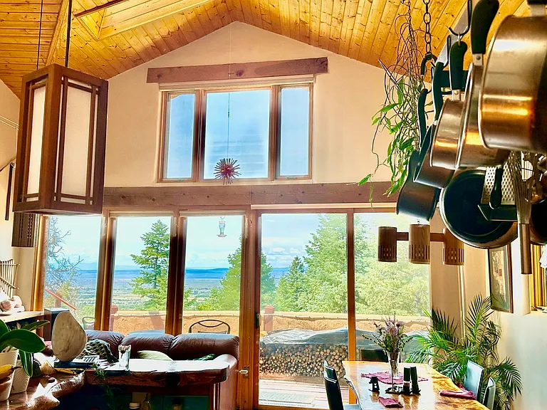 Living/Dining Area valley view with automatic insulated window shades.