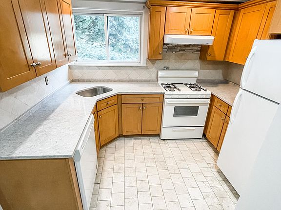 Kitchen with brand new quartz counter tops. A faucet will be installed prior to move in.