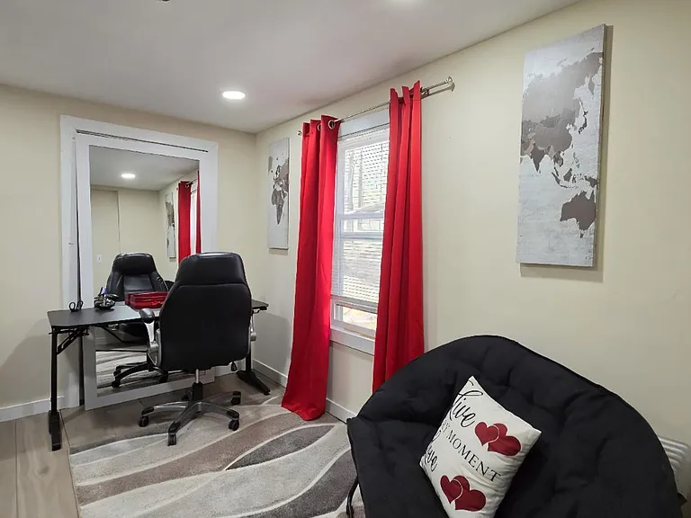 Versatile bonus room with a window and recessed lighting, ideal for a home office or reading nook with seating space.