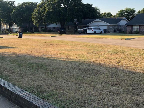 Front yard has curving sidewalk leading to front door.