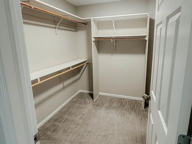 Primary bedroom walk in closet