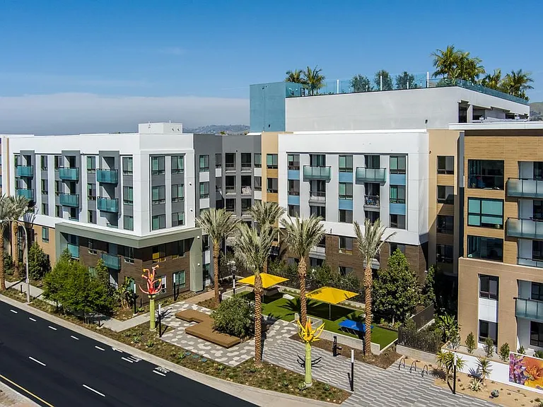 Building A exterior with sculptures and mural artwork