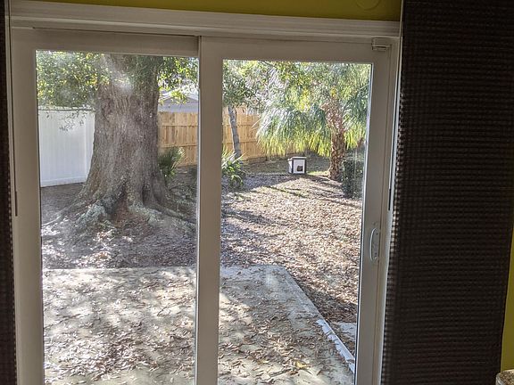 Sliding door off kitchen into large fenced yard