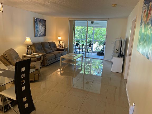 Living room, Dining room from entrance hall. View of balcony.