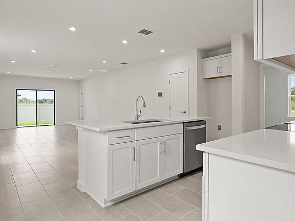 Kitchen Island and view of the living area in the Flagler by DRB Homes in Hamilton Bluff