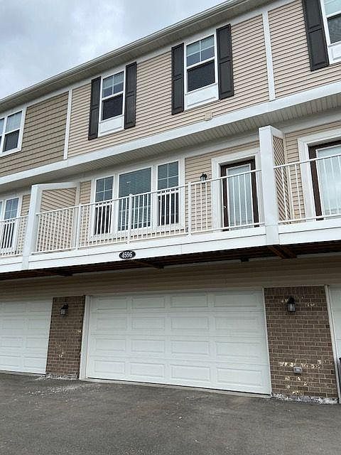 2 car garage entrance with patio above