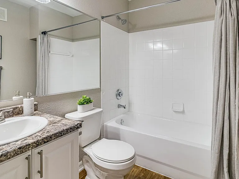Bathrooms feature granite-style counters, wood-style flooring, and a tub/shower combination.