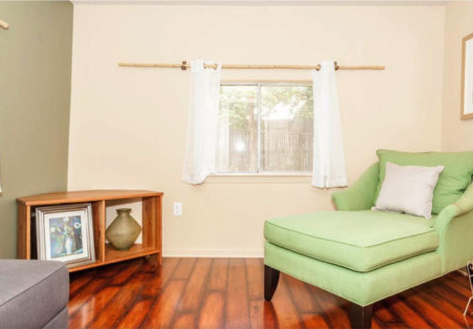 Living room looking into backyard. Cherry flooring replaced with wood-look tile and interior painted white.