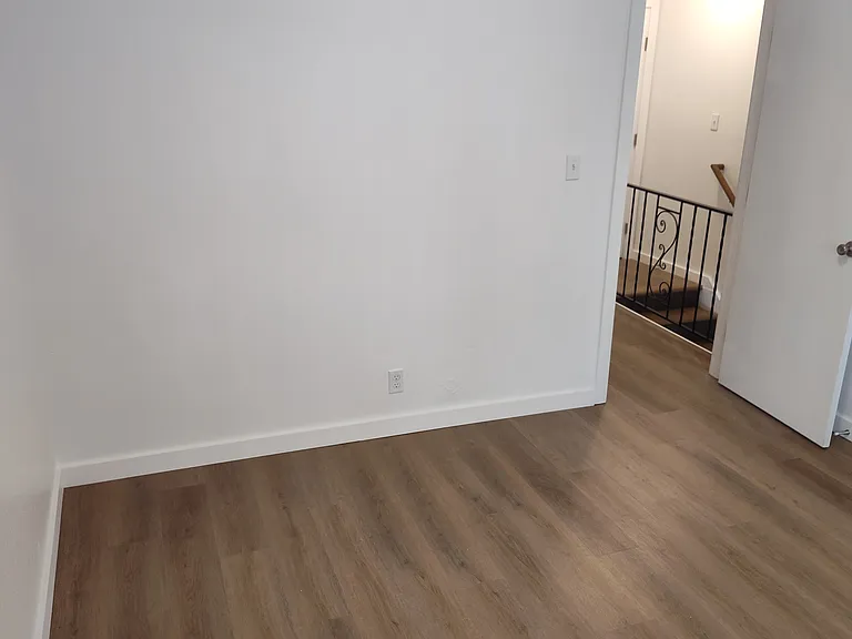 Front Bedroom Standing by the large window.