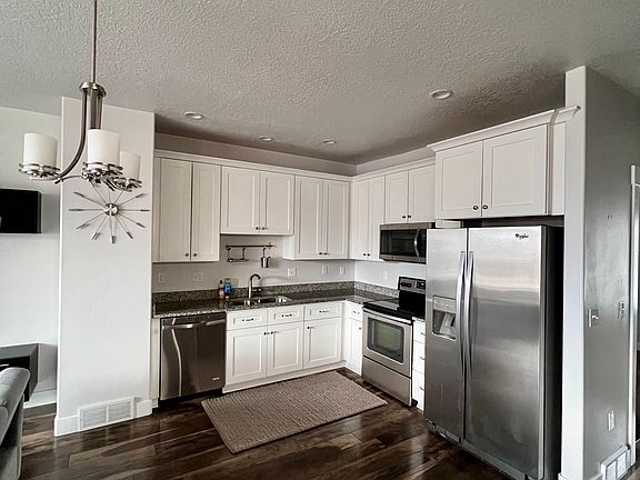 Second Floor: Kitchen with granite countertops and stainless steel appliances