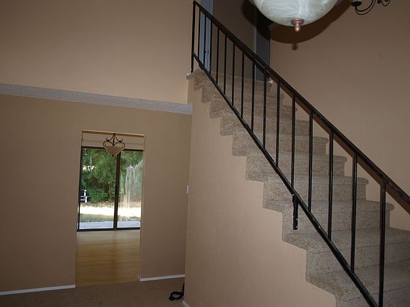 From the front door you can see into the eat in kitchen w/ a view of backyard.