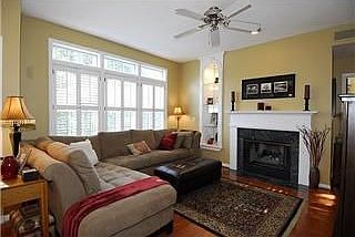 The living room has large windows, gas fireplace, built-in bookcase,h'woods.