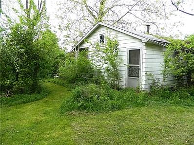 Back of workshop has a second exterior utility door and huge casement window for light. Finished room used to have a pool table - great getaway place or studio!