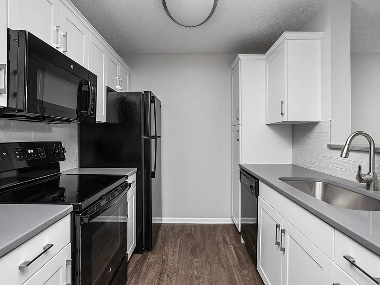 Updated kitchen with white cabinets and quartz countertops