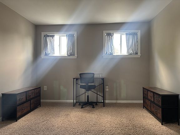 bed-room with desk and two dressers