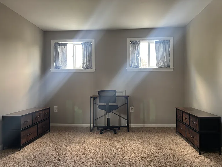 bed-room with desk and two dressers