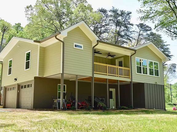 Large Deck with ceiling fan that looks out to backyard.