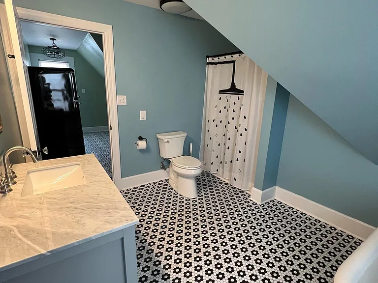 Large bathroom with bathtub and large shower stall.