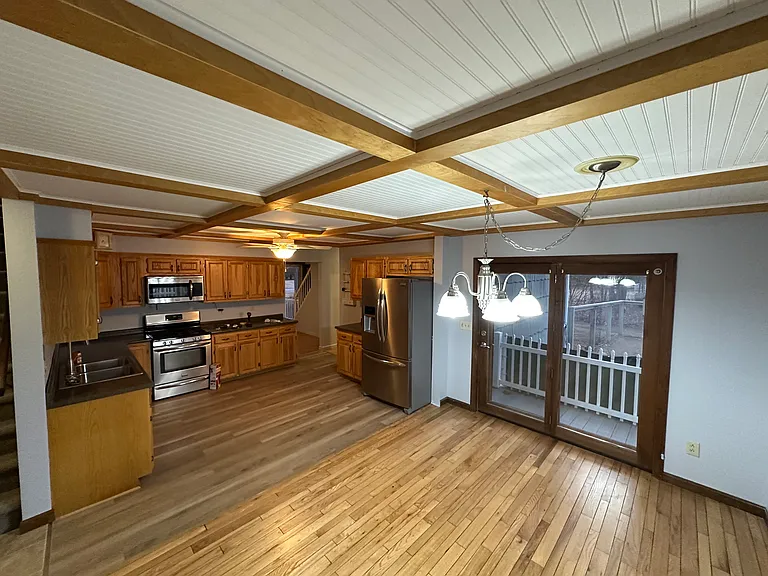 Very large kitchen/ dining room with bay window and french door to back deck, back yard.