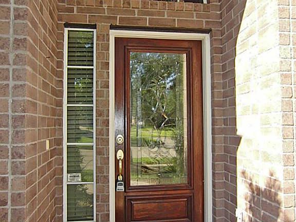 Full Length Leaded Glass Door Welcomes You To This Spacious