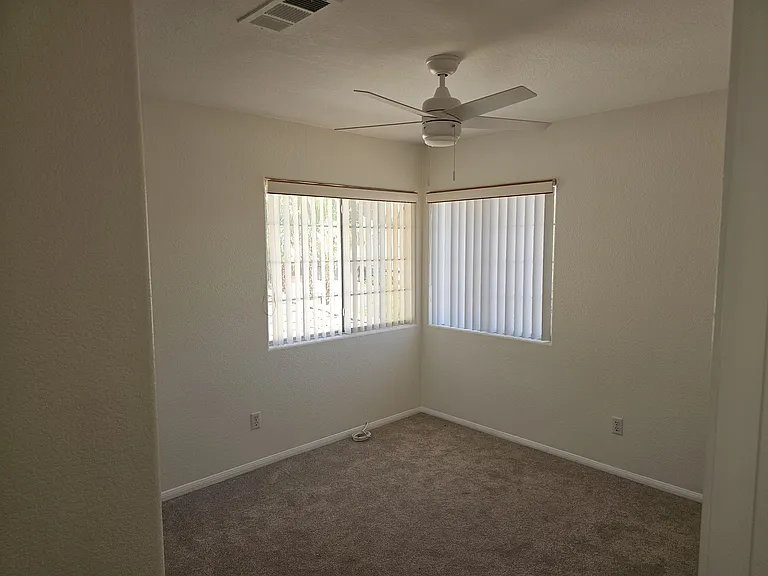 Bedroom #3, ready for personal touches, features soft carpeting and corner windows.