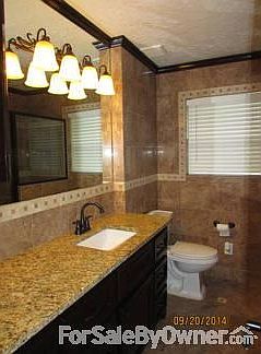 Hall Bathroom
						:
						has custom cabinets, granite countertop and tile all around with a shower