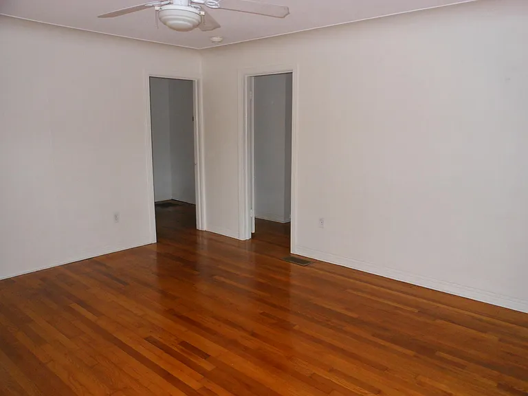 Living room, doors leading to the "bonus room", bathroom, and bedroom