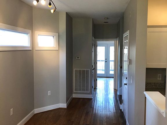 Breakfast Nook and Hallway to back Bedroom/Office, Downstairs Bath, and Stairs to Second Floor
