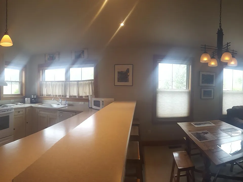 Panorama of the open floor plan including kitchen, dining and living areas.