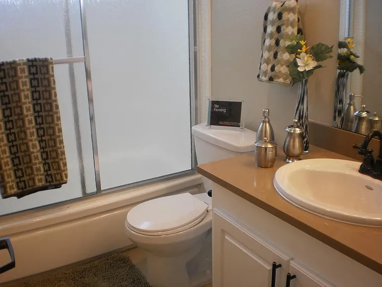Spacious bathroom at the indigo with ceramic tiles and granite counter top