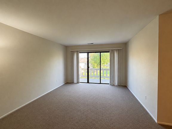 Living Room with 3 pane patio door leading to private balcony