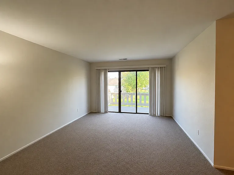 Living Room with 3 pane patio door leading to private balcony