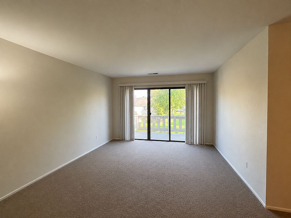 Living Room with 3 pane patio door leading to private balcony