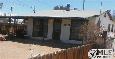 Front of home with covered patio and a large front yard