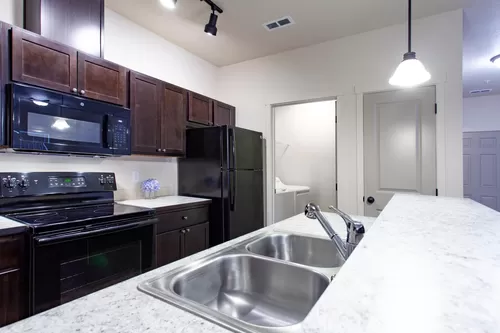 Upgraded apartment homes feature glass cook tops, microwaves, disposal, dishwasher, full size washer/dryer, in-freezer ice maker, sink sprayer, CENTRAL AC, so much more. - The Residence at Whispering Hills