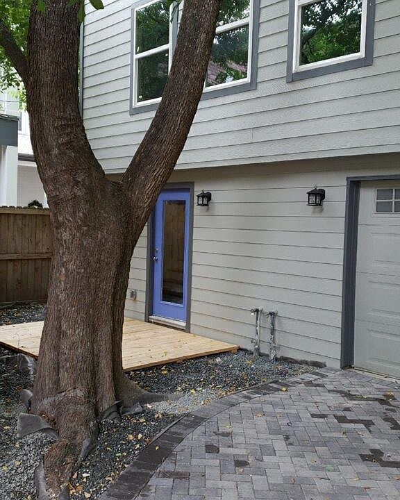 Front entrance with deck. Paved drive way to garage parking-