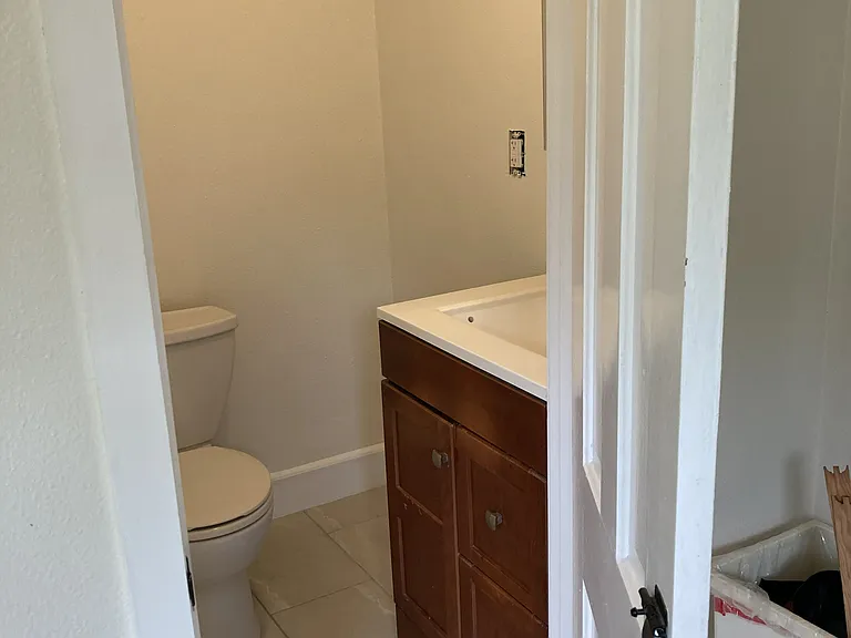 half bath between kitchen and back bedroom