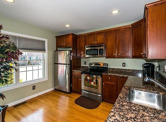 Open kitchen with cherry ca...