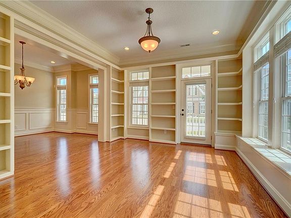 Living room/library with extensive bookshelves