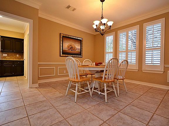 Tremendous space in the dining room, plantation shutters and easy access to the kitchen.