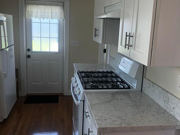 Kitchen with door leading to backyard and patio area