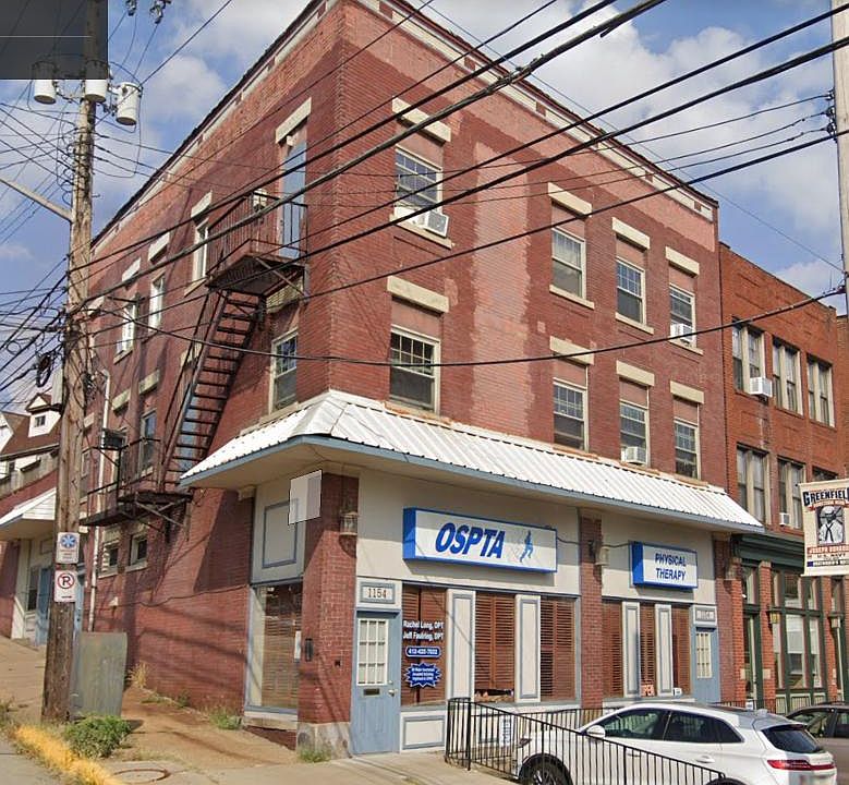 Corner lot building - large picture windows wrapping the building.