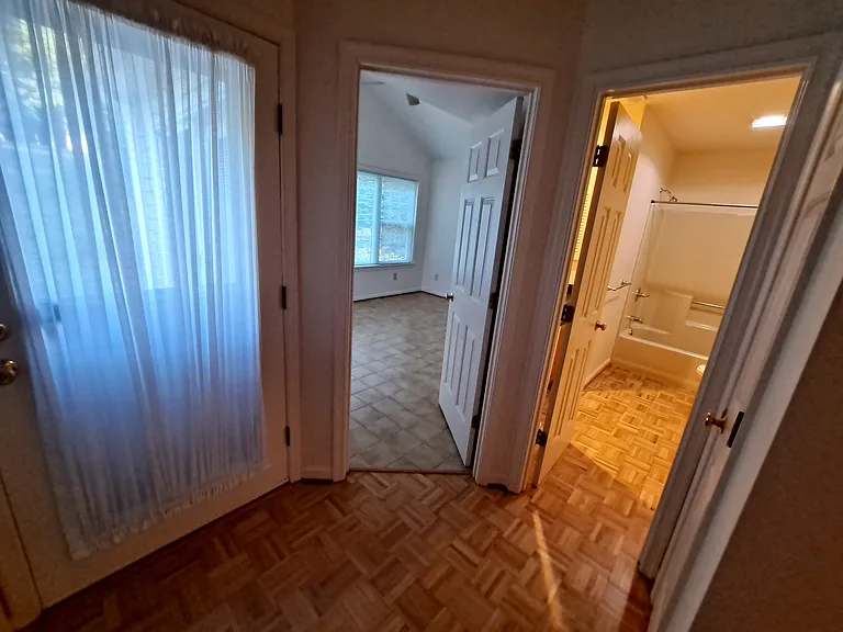 back hallway exit to patio, doors to bedrooms and bath